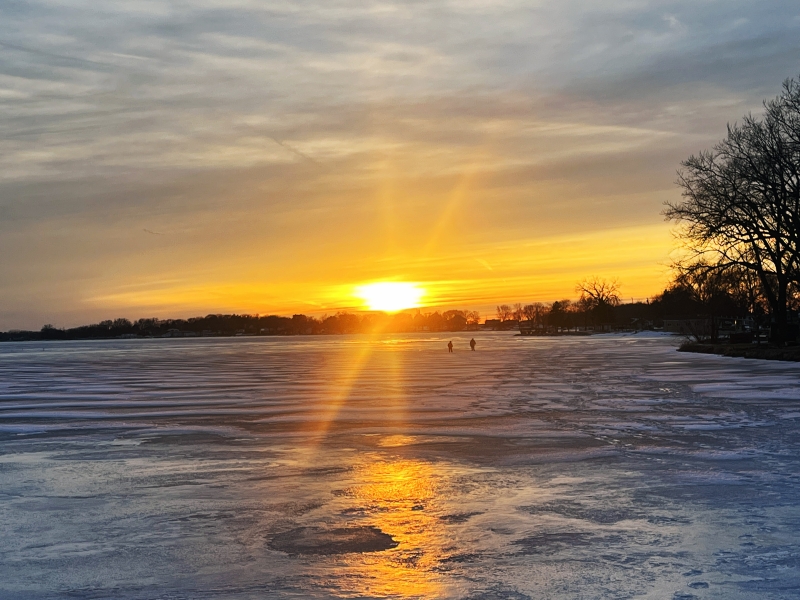 Radiant sunset over frozen lake